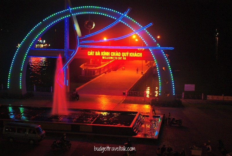 The welcome sign at the jetty on the esplanade. You can see the lights of a floating restaurant on the left.