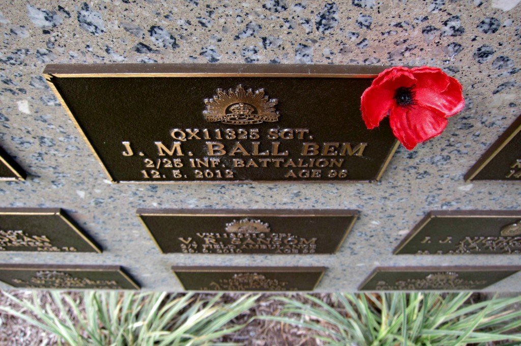 A Poppy tucked into a memorial plaque -Anzac Day - N.Q. Garden of Remembrance