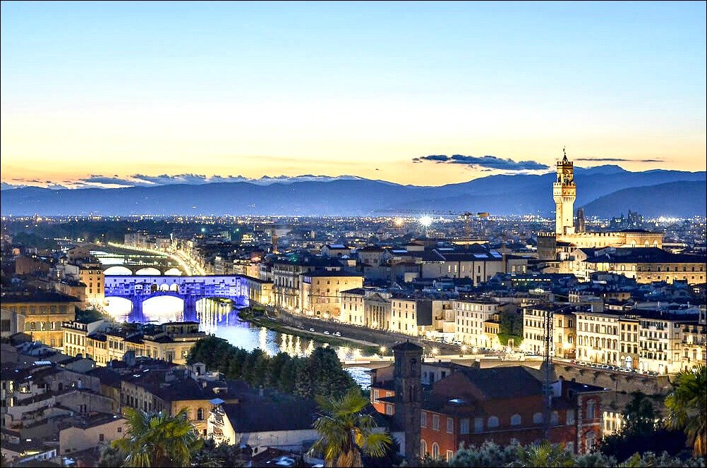 This photo of florence_piazzale michelangelo at dusk with the distant blue mountains and coloured bridge and river.