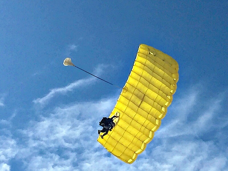 Looking up to the yellow parachute of sky divers landing at Stumers Creek north of Coolum Beach